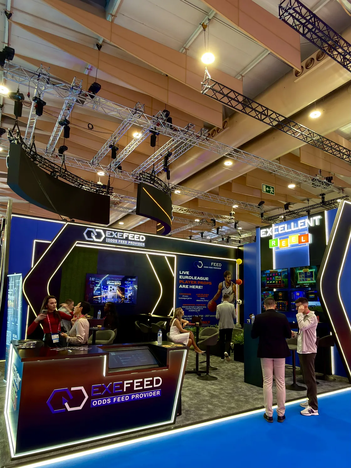 The exhibition stand at SBC Summit Lisbon, with the games counter and screens behind