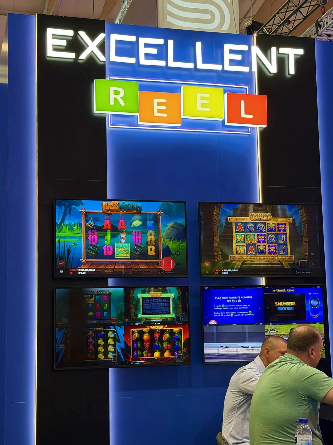 The Excellent Reel logo wall, with four screens running live titles
